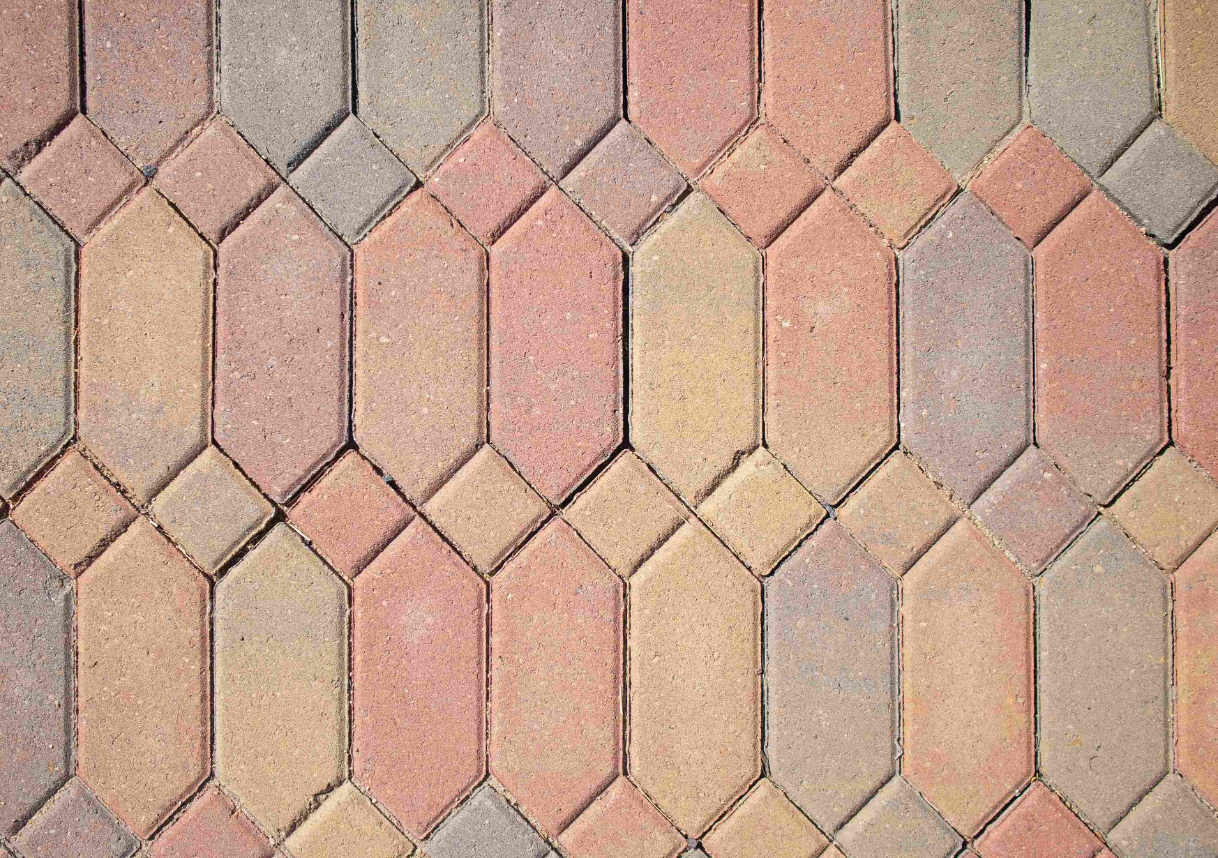 Coloured concrete with a brick pattern.