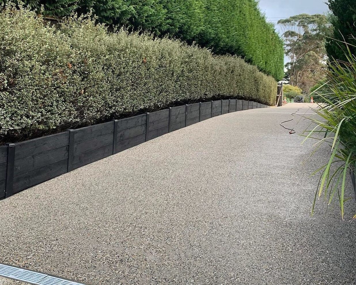 Driveway with an exposed aggregate concrete design.